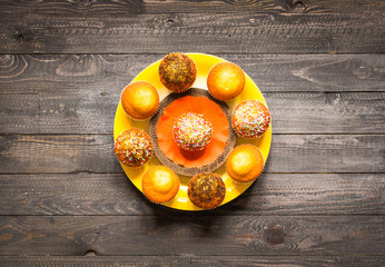 Fototapeta na wymiar Delicious homemade muffins with yogurt, on a wooden background with space for text.