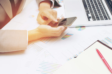 Young businessman working at office, writes marketing plans and on the notepad strategy diagram as concept morning light for online business, business concept : computer and internet are required.