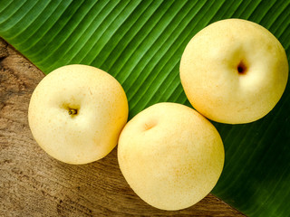 Asian pears or Chinese pears fresh from the farm with green banana leaf background.