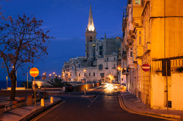 Valletta seafront at night with St. Paul's Anglican Cathedral, Malta