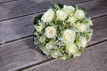 Bridal Bouquet with white Roses on wooden Plank