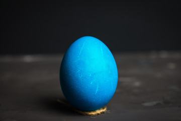 Colored easter egg on the dark background. Shallow depth of field.
