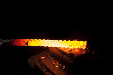 Blacksmith working on a piece of metal