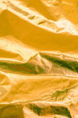 Closeup of yellow wrinkled paper texture background