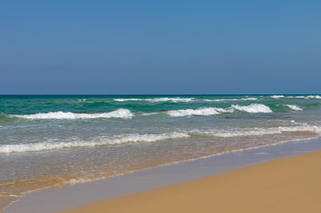 Peaceful ocean wave at beach. Smooth sand.