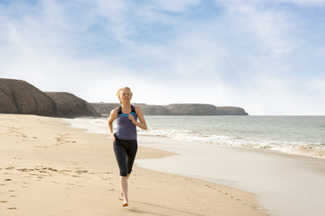 Healthy Woman Jogging Along the Beach