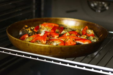 The fish in the pan with the red pepper and spices