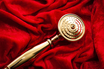 Golden showerhead wrapped in red velvet. In urban slang and the adult industry the term golden...