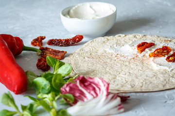 Tortilla with ricotta and sun-dried tomatoes. Healthy snack concept.