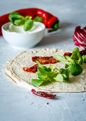 Tortilla with ricotta and sun-dried tomatoes. Healthy snack concept.