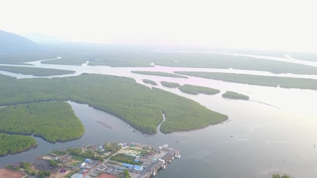 Aerial drone footage of fishing port and mangroves in Thailand
