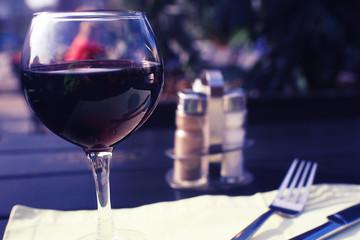Serving a glass of red wine in a restaurant