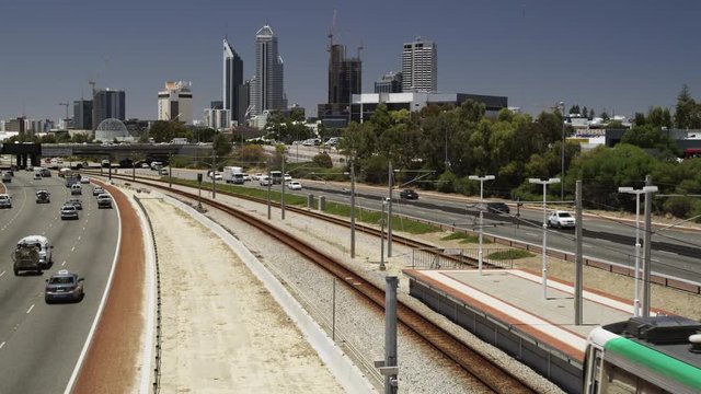 View of Traffic And Transperth Suburban Train With Skyline in Background