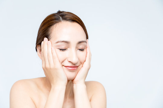 beautiful woman massaging her face. lymphatic massage.