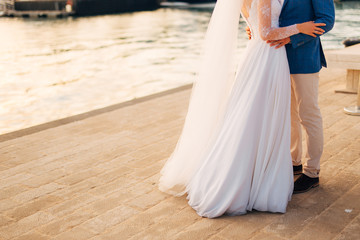Fototapeta na wymiar Female and male feet on the pavement. Wedding in Montenegro