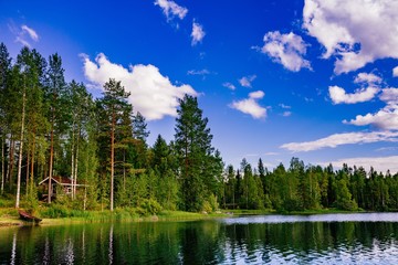 Obraz premium Wooden sauna log cabin at the lake in summer in Finland