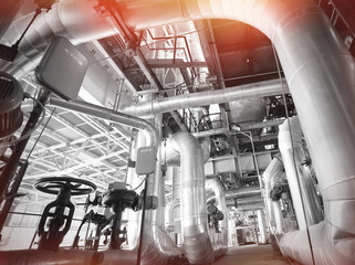 Equipment, cables and piping as found inside of a modern industrial power plant