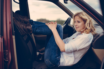 Cute, young woman in off road vehicle during road trip. Lifestyle concept.