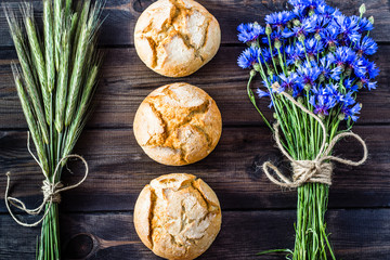 Fresh buns on rustic wooden table, bakery products , flat lay