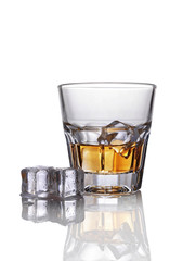 Glass of scotch whiskey with ice cube