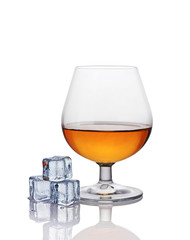 Glass of cognac with ice cube