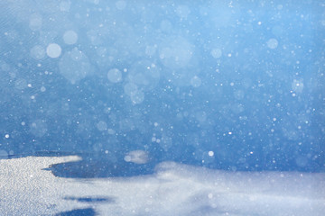 blurred winter background with snowflakes for text