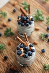 Chia pudding with blueberries and almonds in small bowls on wooden background