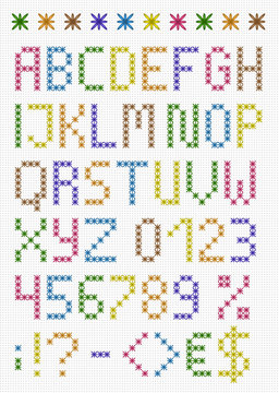 Colorful stitched uppercase english alphabet with numbers and symbols. Isolated on white cloth texture