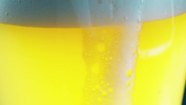 White Foam Sliding Down Of Beer Glass. 4k UltraHD Video