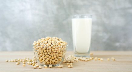 soybean in a bowl and soy milk on a wooden background.