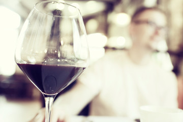 Serving a glass of red wine in a restaurant