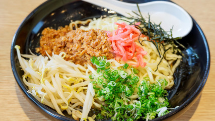 Hot ramen noodle (Japanese food) in a black bowl, soft focus.