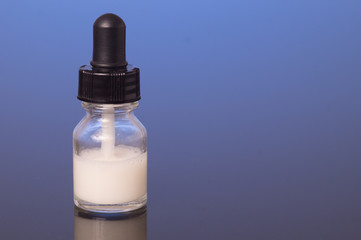 dropper bottle with milk white liquid