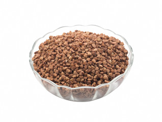 Buckwheat grains on a transparent saucer isolated on white background