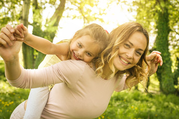 Fototapeta premium Mother and daughter outdoors in a meadow.