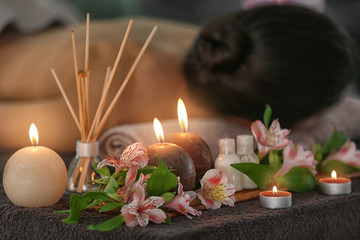 Beautiful spa composition with candles and flowers in modern wellness center
