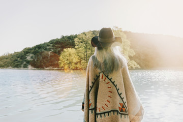 Boho style woman walking on lake
