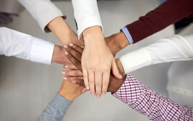 business team with hands on top at office