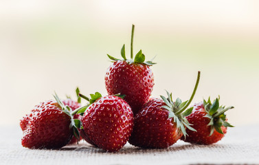 red close up strawberries with selective focus on a strawberry with many strawberries