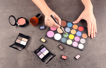 Obraz na płótnie Canvas Female makeup artist with cosmetics at work