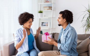 happy couple with gift box at home