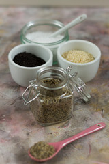 Gomasio- sesame salt. Jar, small bowls with ingredients. 
