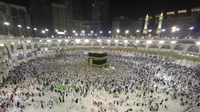 Time lapse video of Muslim pilgrims circling around the holy Kaaba at night during Hajj inside al Masjid al Haram in Mecca, Saudi Arabia. Camera zooms in through the Kaaba.