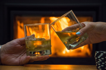Rest by the fireplace with a glass of whiskey while playing poker