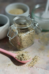 Gomasio- sesame salt. Jar, small bowls with ingredients. 