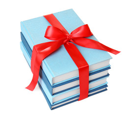 Stack of books with ribbon as gift on white background