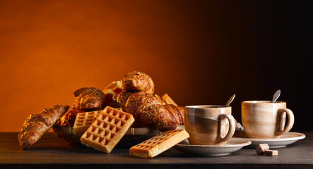 Breakfast with black coffee and fresh pastries