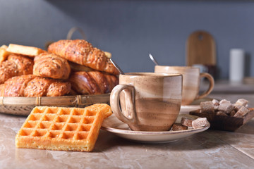 Breakfast with black coffee and fresh pastries