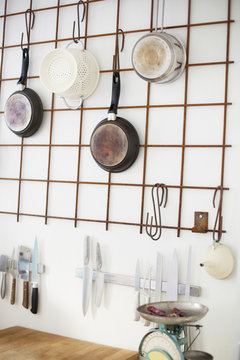 Cooking utensils hanging on wall in kitchen