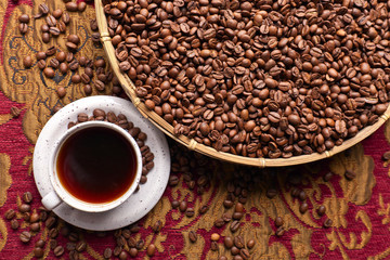 Cup of black coffee and  beans